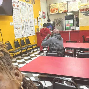 a woman sitting at a table in a fast food restaurant