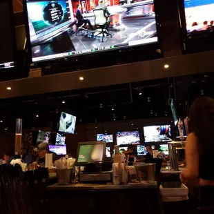 a bar with multiple televisions