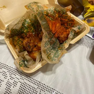 two take out containers of food on a table