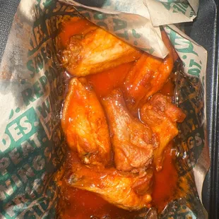 a tray of chicken wings and sauce