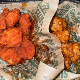 a basket of fried chicken with a side of pickles