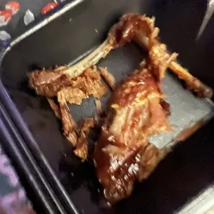 Broken pieces of chicken it looks like it was frying for hours