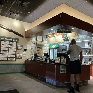 a man ordering food at a counter