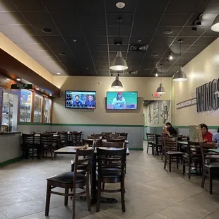the inside of a restaurant with tables and chairs