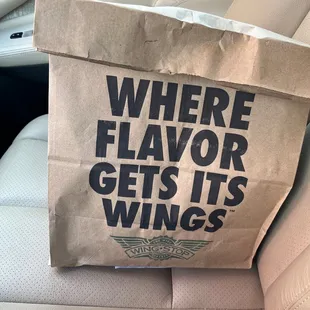 a paper bag with the words where flavor gets its wings