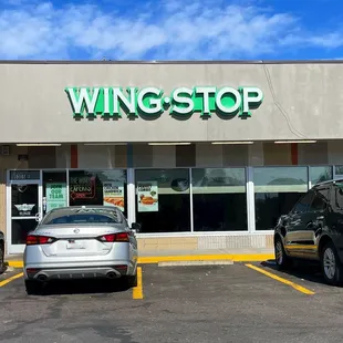 two cars parked in front of the store