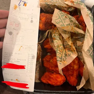 a person holding a receipt and a remote control