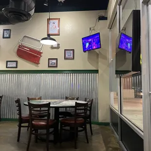 a view of a dining area with a table and chairs