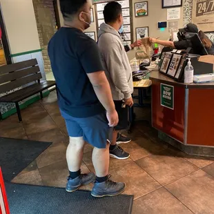 two men standing in front of a counter