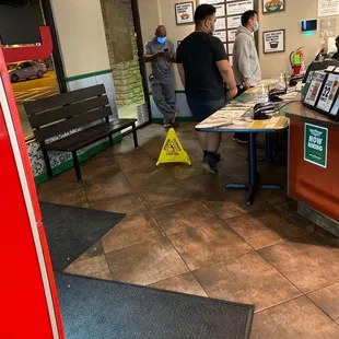 people standing at a counter in a restaurant