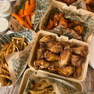 a variety of wings and french fries