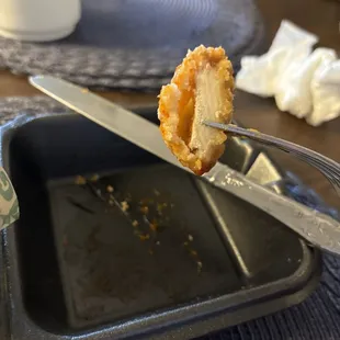 a half eaten pastry being held by a fork