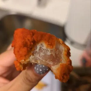 a person holding a piece of food