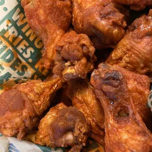 a close up of a basket of chicken wings