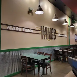 the inside of a restaurant with tables and chairs