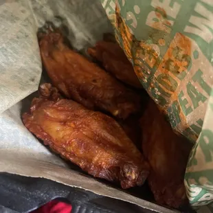 a close up of a bag of chicken wings