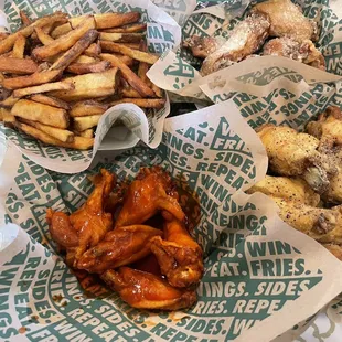 a variety of wings and fries on a table
