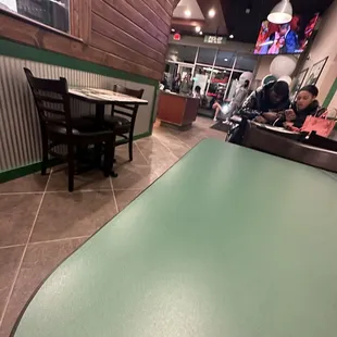 a person sitting at a table in a restaurant