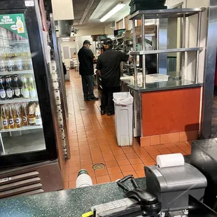 Employee standing around even leaning on shelf&apos;s.
