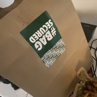 a brown paper bag with a logo on it