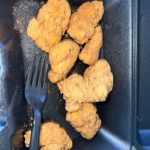 fried chicken in a plastic container with a fork