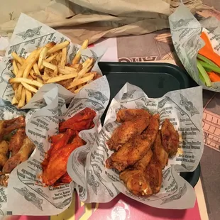 ~24$ for two people. 20 wings, fries veggies