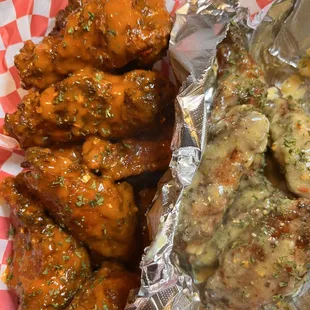 a basket of chicken wings and a side dish