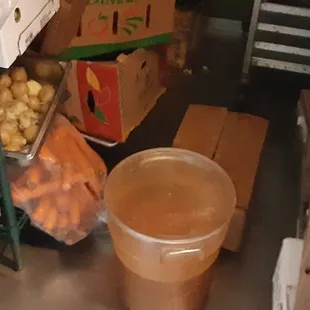 Uncovered cooked meat below raw chicken.  Food "stored" on the floor