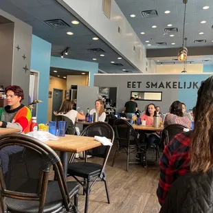 people sitting at tables in a restaurant