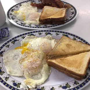 two plates of breakfast food