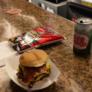 a burger and a drink on a counter