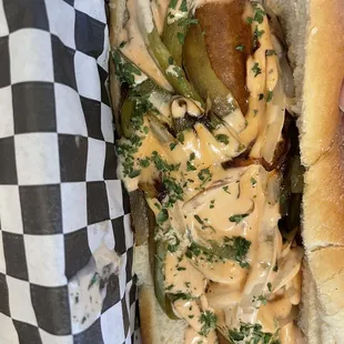 Vegan dog with pepper, onions &amp; sauce