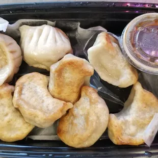 House Made Pan Fried Pork Dumplings with a dipping sauce.