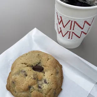 a chocolate chip cookie and a cup of coffee