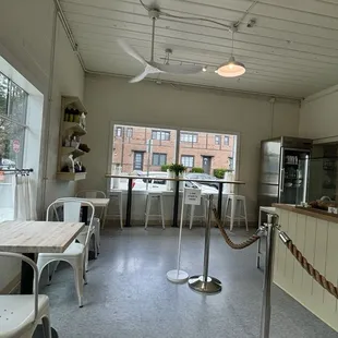 Inside view of the bakery with tables to enjoy your bites inside.