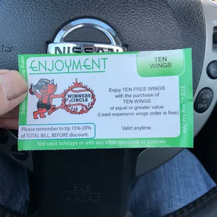 a driver's hand holding a car's driver's license