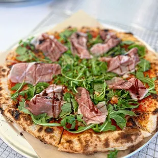 pizza with meat and greens