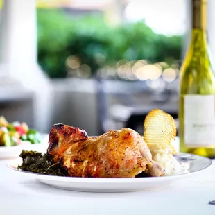 Rotisserie Chicken served with slow cooked collards and mashed potatoes