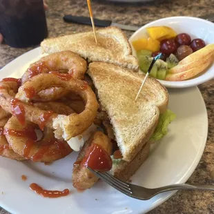 BLT with onion rings and fruit.