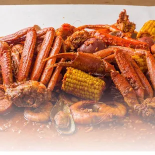 a pile of crab legs and corn on the cob