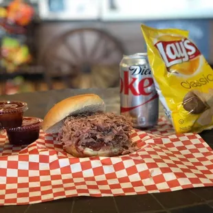 ows a pulled pork sandwich and chips