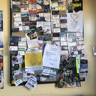 ows a bulletin board full of business cards