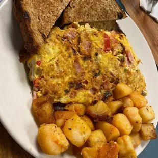 an omelet with potatoes and toast
