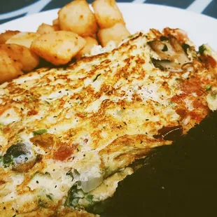 an omelet and potatoes on a plate