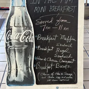 a chalk board with a coca cola sign