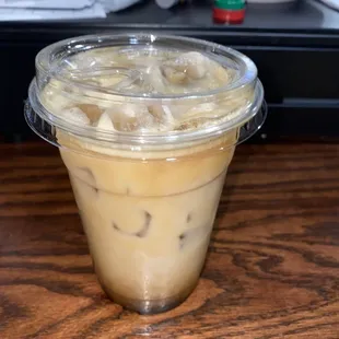 a cup of iced coffee on a table
