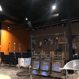 a room with chairs, tables, and televisions