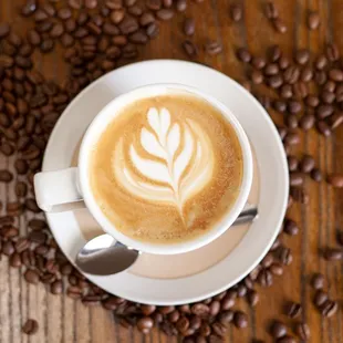 a cup of coffee on a wooden table