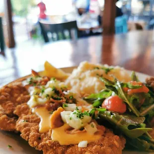 Pretzel Schnitzel with mashed potatoes and arugula salad.