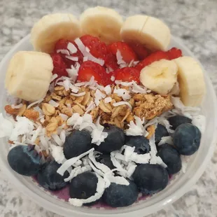 The "OG" smoothie bowl topped with fresh fruit, granola and coconut shavings